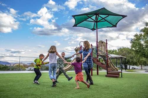 small children playing at a park during cloudy day